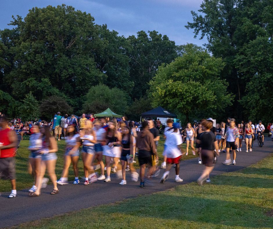  A timelapse image of crowds walking through the golf course during the independence day celebration