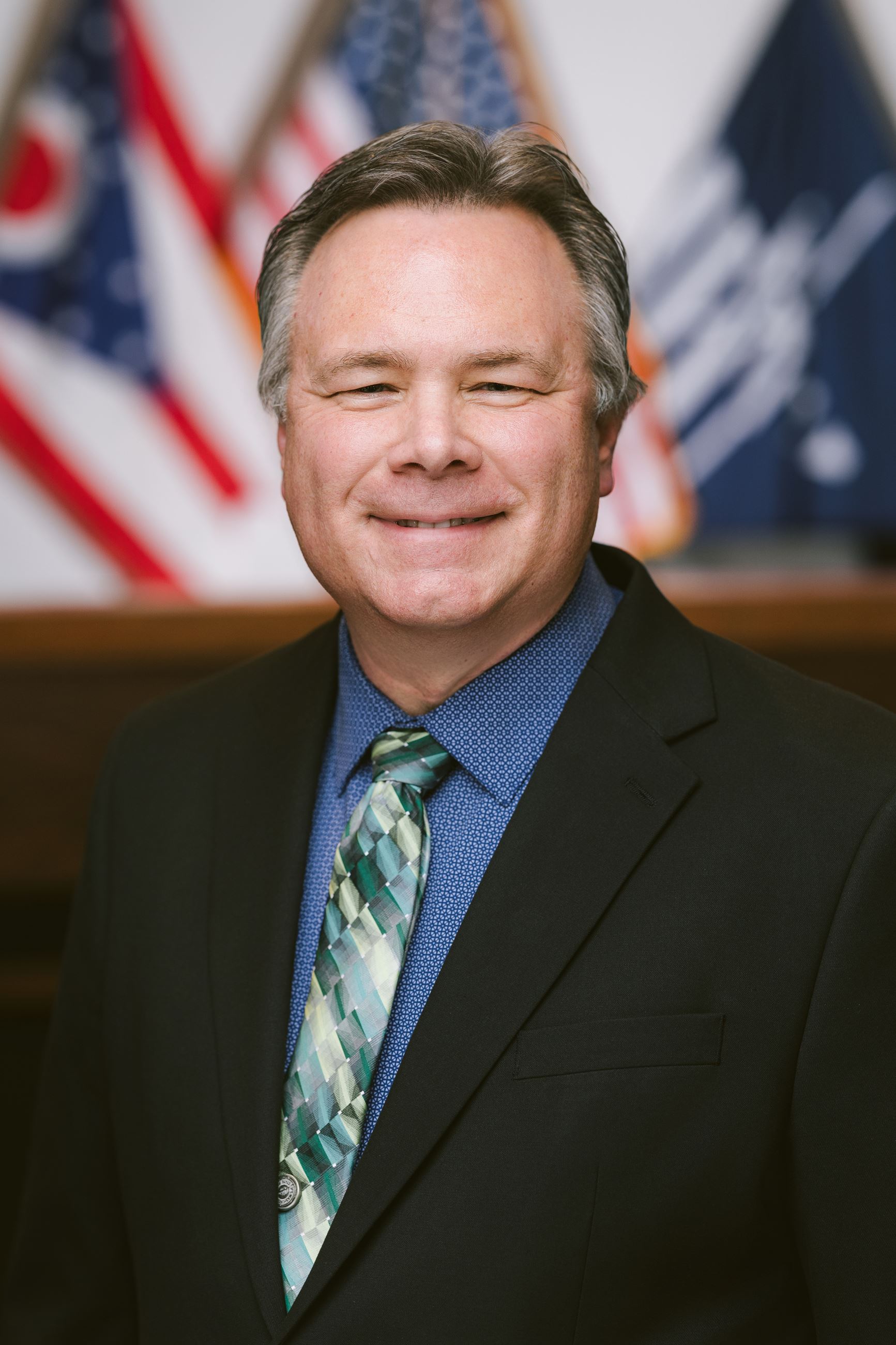 Man smiles at camera.