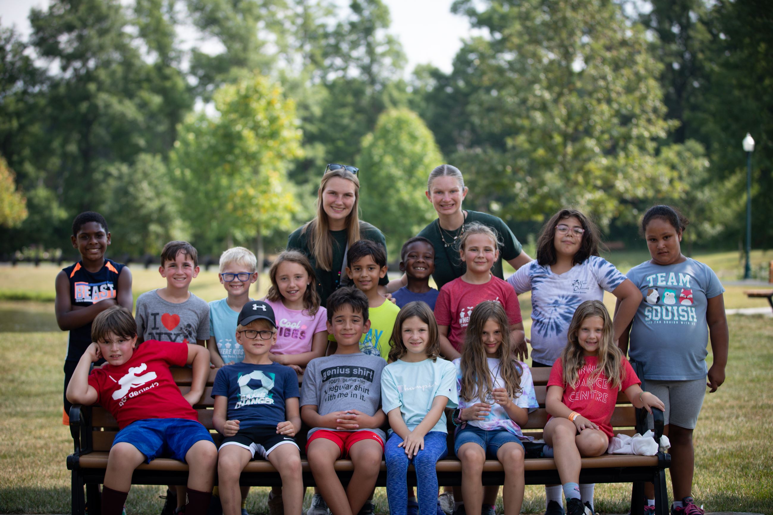 A group of campers and camp counselors together on a sunny day